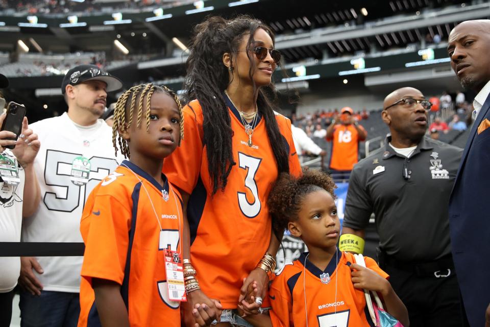 Future Zahir Wilburn, Ciara Wilson, wife of Russell Wilson #3 of the Denver Broncos, and Sienna Princess Wilson look on from the field before the game between the Denver Broncos and Las Vegas Raiders at Allegiant Stadium on October 02, 2022 in Las Vegas, Nevada.