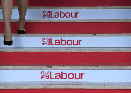 A delegate walks down a branded staircase at the Labour party Conference venue in Brighton, Britain, September 25, 2017. REUTERS/Toby Melville