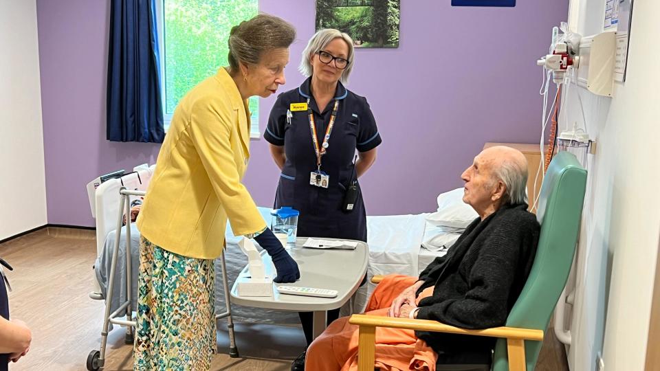 Princess Anne meeting Dennis, who is in a chair