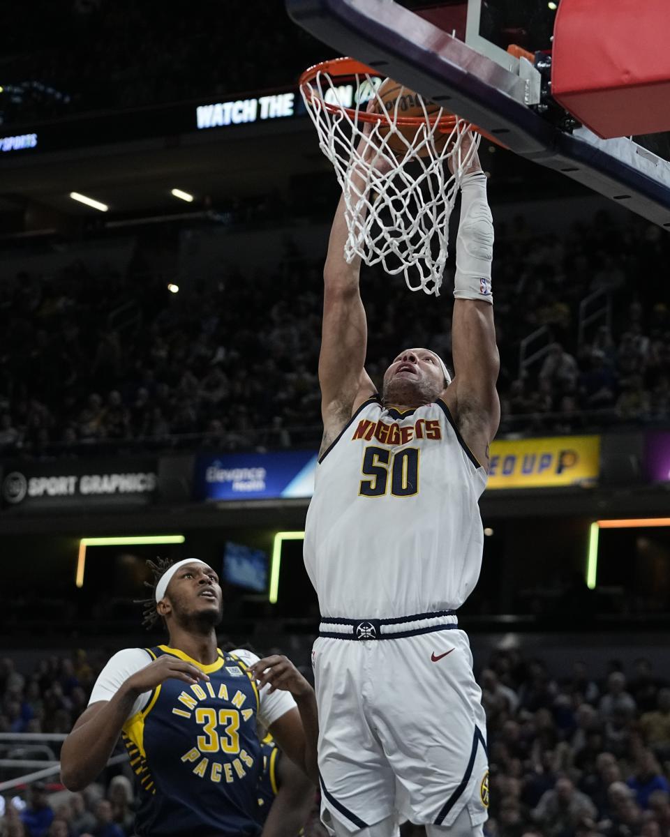 Denver Nuggets' Aaron Gordon (50) dunks against Indiana Pacers' Myles Turner (33) during the first half of an NBA basketball game, Tuesday, Jan. 23, 2024, in Indianapolis. (AP Photo/Darron Cummings)