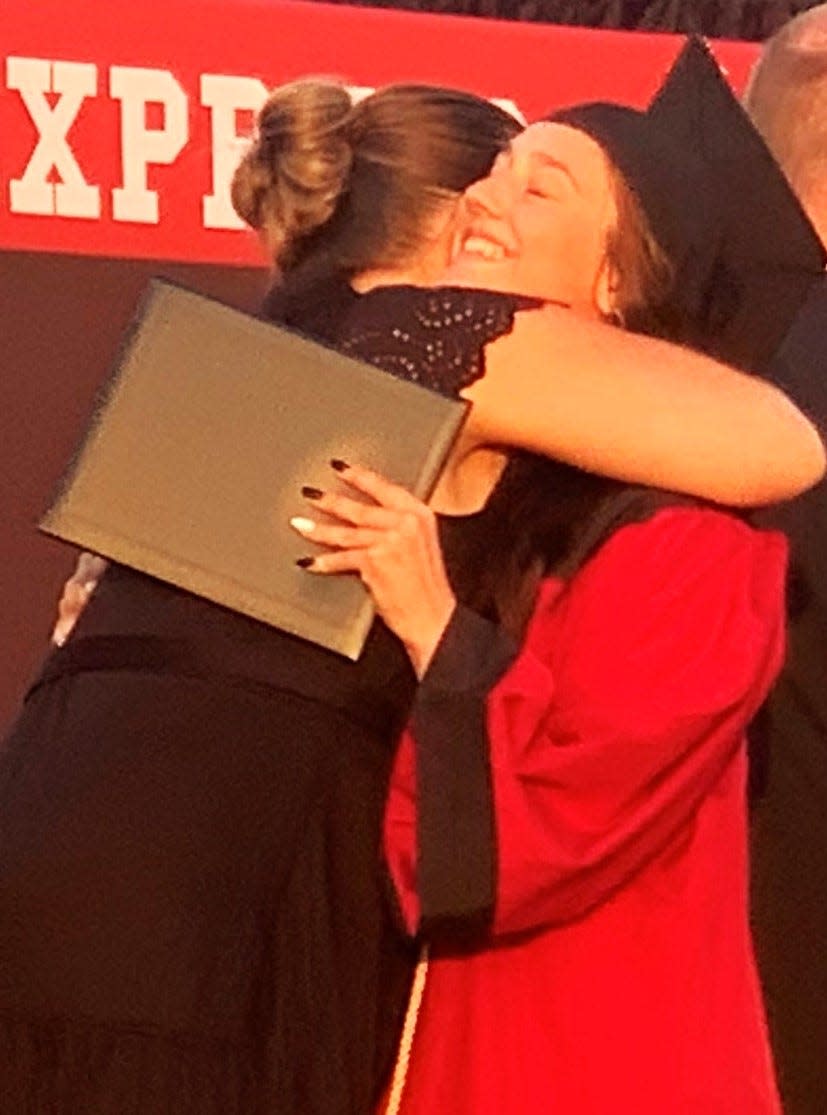 Hugs were common during the Elmira High School graduation ceremony Thursday, June 20, 2024 at the high school athletic field