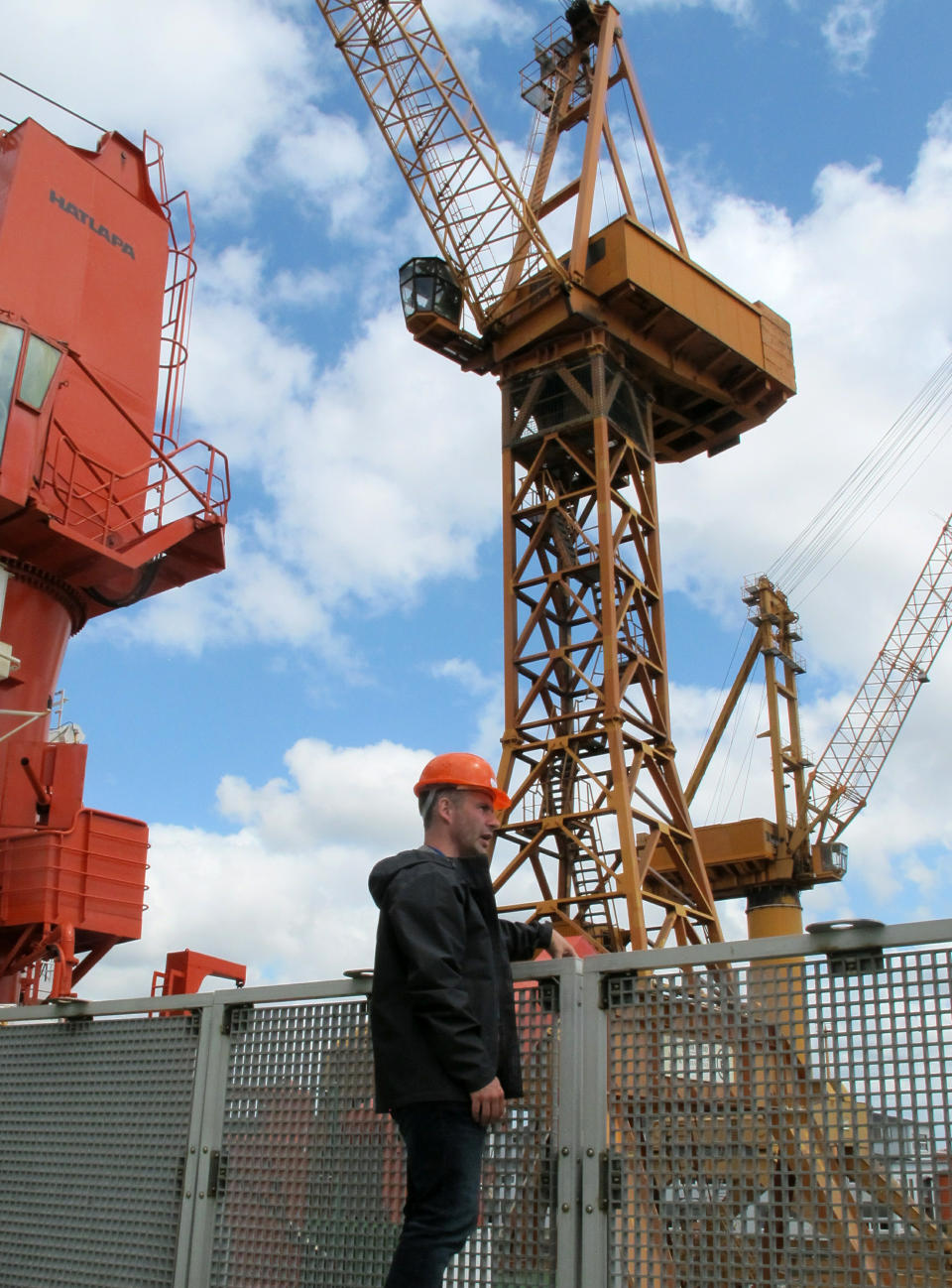 Sea ice physicist Marcel Nicolaus stands on the helicopter deck of the German Arctic research vessel Polarstern in Bremerhaven, Germany, Wednesday, July 3, 2019. Scientists from 17 nations are preparing for a year-long mission to the central Arctic to study the impact that climate change is having on the frigid far north of the planet. Mission leader Markus Rex said that researchers plan to anchor the German icebreaker RV Polarstern to a large floe and set up camp on the ice as the sea freezes around them, conducting experiments throughout the Arctic winter. (AP Photos/Frank Jordans)