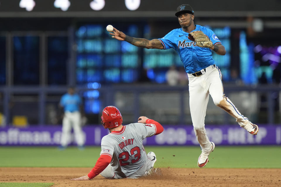 Los Angeles Angels' Brandon Drury (23) is forced out as Miami Marlins shortstop Tim Anderson (7) throws to first to complete the double pay during the eighth inning of a baseball game, Wednesday, April 3, 2024, in Miami. The Angels defeated the Marlins 10-2. (AP Photo/Marta Lavandier)