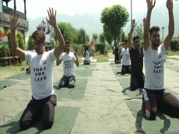 Visual of yoga being practised near Dal lake (Photo/ANI)