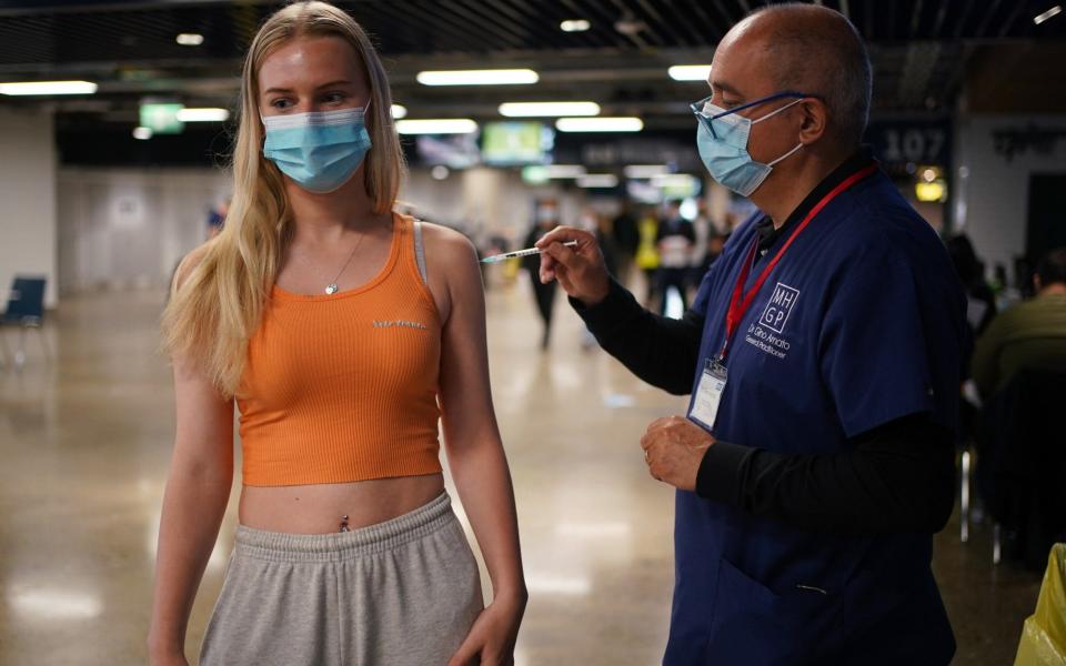 Maisie Ayres, 18, receives a Pfizer Covid-19 vaccine at Tottenham Hotspur's stadium in north London on 20 June 2021 - Yui Mok/PA