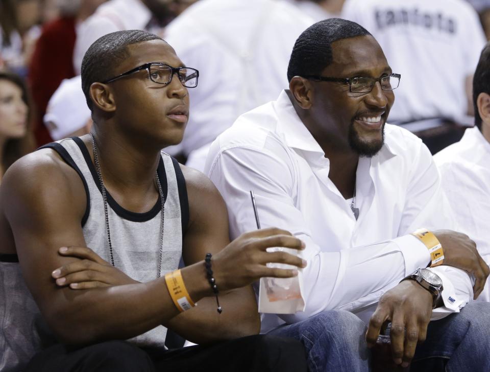 Former NFL player Ray Lewis, right, and his son Ray Lewis III attend an NBA playoff  game in 2013 in Miami.
