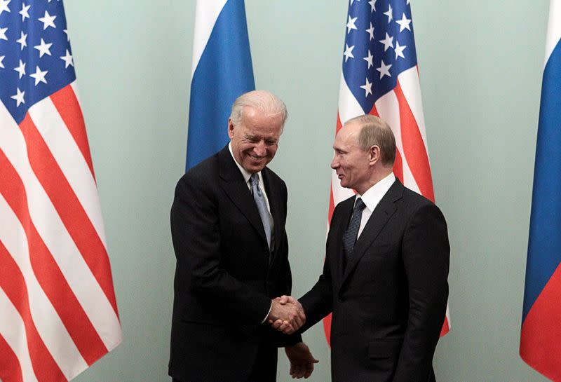 FILE PHOTO: Russian Prime Minister Putin shakes hands with U.S. Vice President Biden during their meeting in Moscow