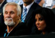 FILE PHOTO: Rogers and his wife Wanda Miller watch the match between Nadal of Spain and Cilic of Croatia at the Australian Open tennis tournament in Melbourne