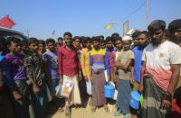 In this Wednesday, April 1, 2020, photo, Rohingya refugees stand at the Kutupalong refugee camp, Cox’s Bazar, Bangladesh. Aid workers are bracing for a possible outbreak of the coronavirus in one of the world's largest refugee camps in Bangladesh, but officials are already warning that containing the disease among more than 1 million tightly packed Rohingya Muslims will be a daunting task. (AP Photo/Suzauddin Rubel)