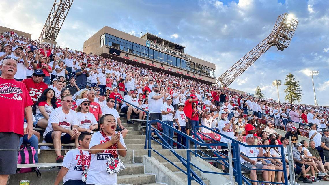 Fresno State fans cheer on the team while dressed mostly in white during their home opener “white out” game against Eastern Washington at Valley Children’s Stadium on Saturday, Sept. 9, 2023.