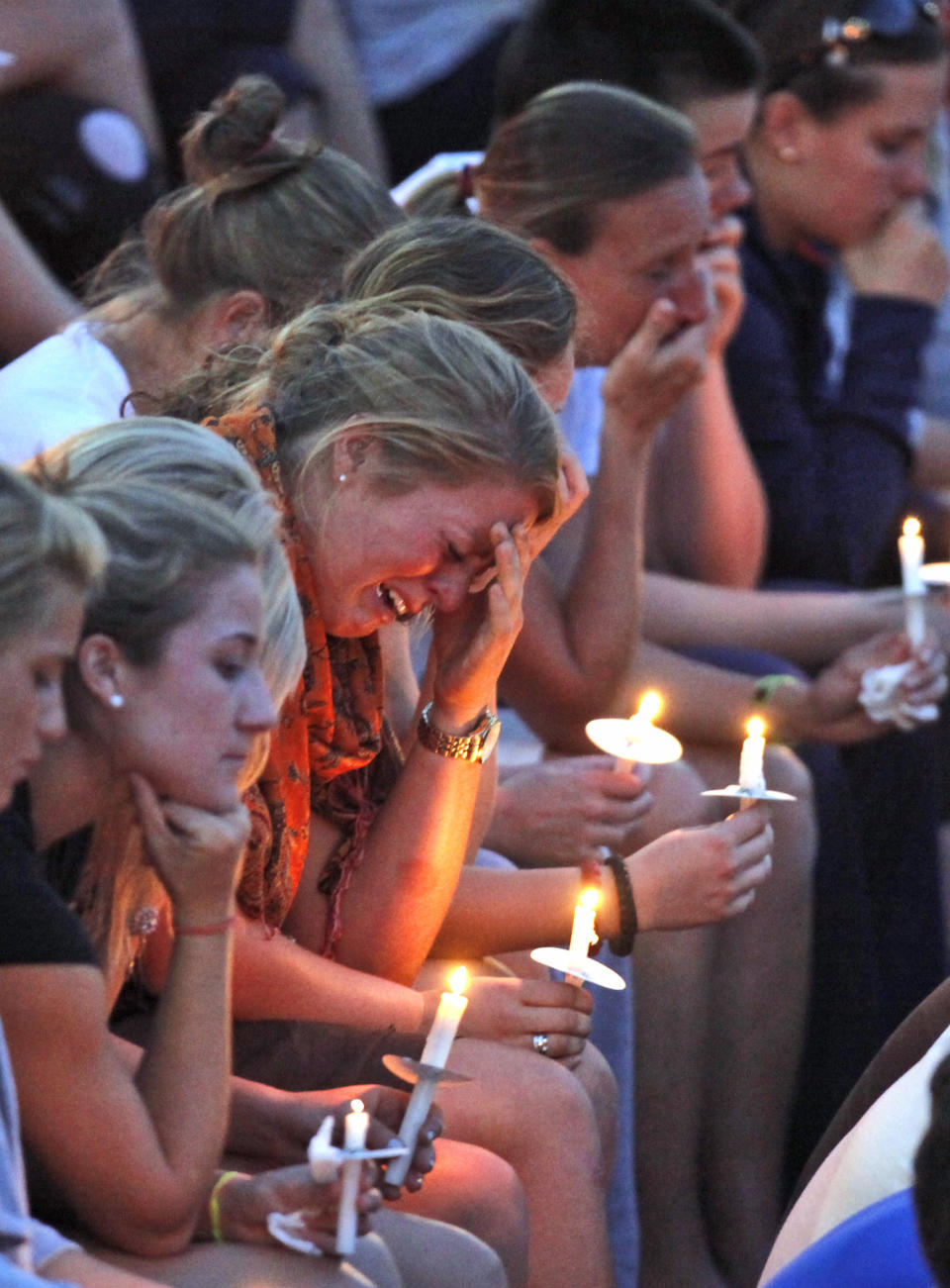 FILE - Members of the Virginia women's lacrosse team hold candles during a memorial for teammate Yeardley Love at the school in Charlottesville, Va., Wednesday, May 5, 2010. Nearly 12 years after University of Virginia lacrosse player Yeardley Love was found dead, George Huguely, convicted of second-degree murder in her killing is headed back to court for a civil trial. Jury selection is expected in Charlottesville Circuit Court Monday, April 25, 2022 in a trial that will seek to hold George Huguely V liable in the death of Love. (AP Photo/Steve Helber, File)
