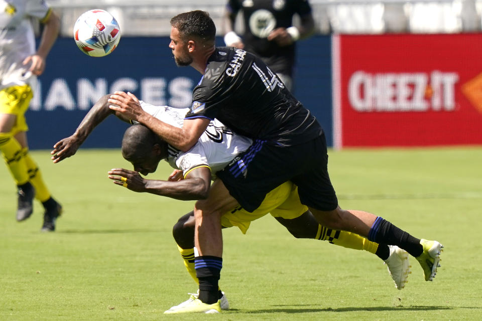 Columbus Crew forward Bradley Wright-Phillips, left, and CF Montréal defender Rudy Camacho (4) battle for the ball during the first half of an MLS soccer match, Saturday, May 1, 2021, in Fort Lauderdale, Fla. (AP Photo/Lynne Sladky)