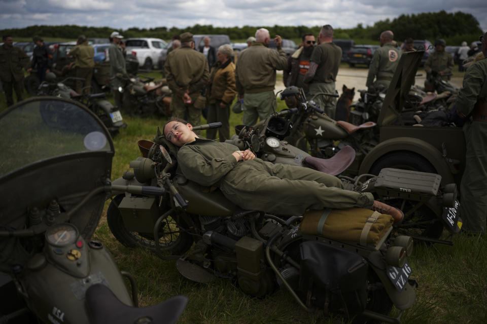 A reenactor rests on a US army vintage Harley Davidson motorbike at Utah Beach near Sainte-Marie-du-Mont, Normandy, France, Tuesday, June 4, 2024. Some 150 vintage US Army Harley Davidson motorbikes on Tuesday took part in a road parade near D-Day landing beaches. (AP Photo/Daniel Cole)