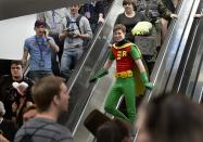 A man in a "Robin" suit arrives at the opening day of Salt Lake Comic Con, Thursday, April 17, 2014, in Salt Lake City, Utah. (AP Photo/The Salt Lake Tribune, Scott Sommerdorf)