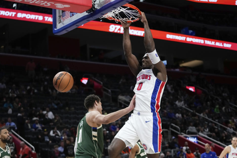 Detroit Pistons center Jalen Duren (0) dunks on Milwaukee Bucks center Brook Lopez (11) in the second half of an NBA basketball game in Detroit, Monday, Jan. 22, 2024. (AP Photo/Paul Sancya)