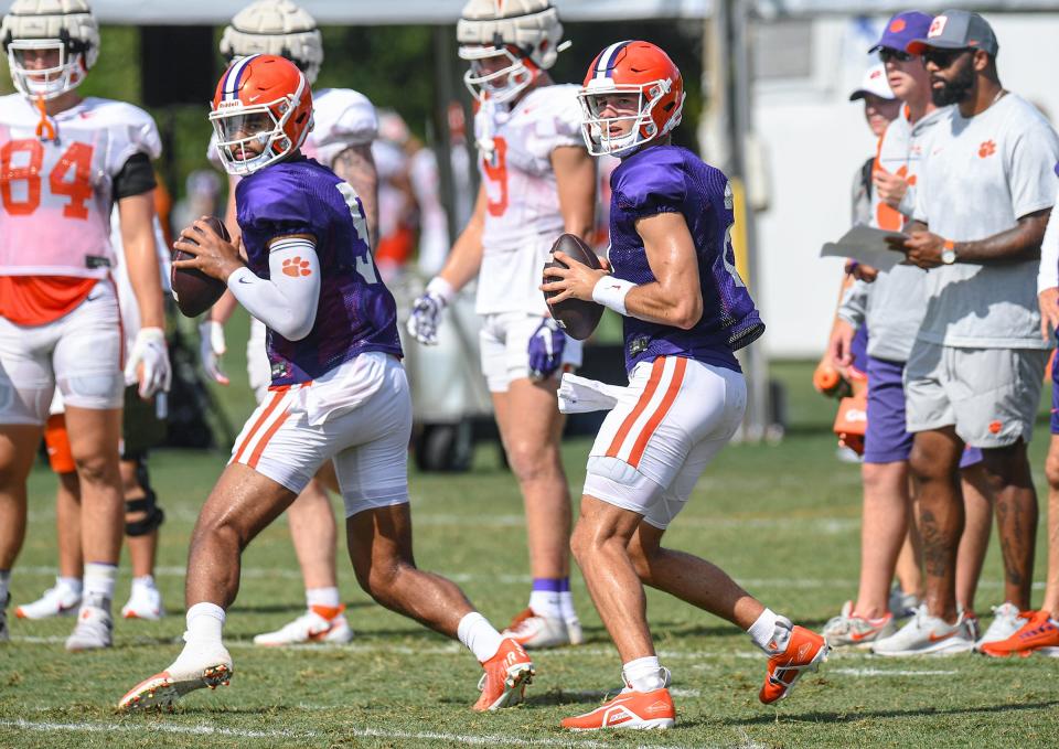 Clemson quarterback D.J. Uiagalelei (5), left, and quarterback Cade Klubnik (2) fade back to pass during practice in Clemson Friday, August 12, 2022. 