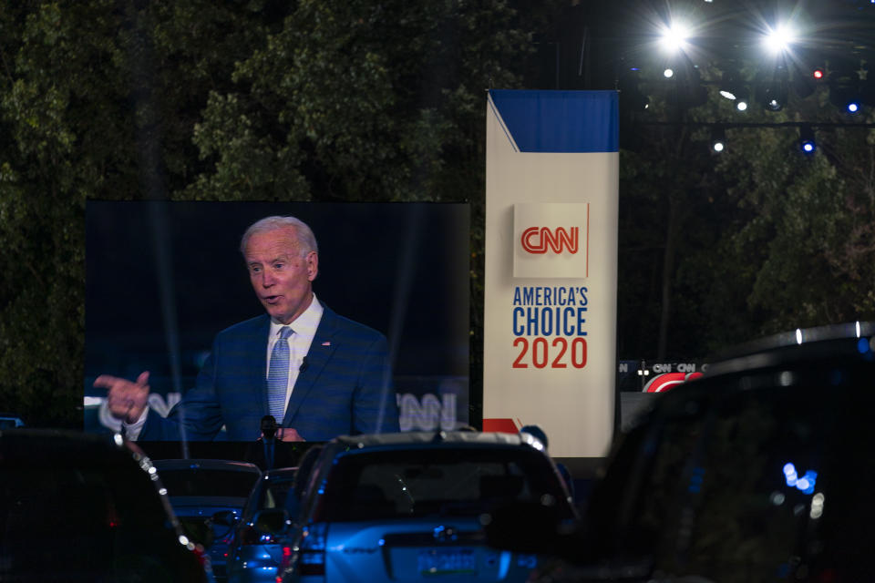 Audience members watch from their cars as Democratic presidential candidate former Vice President Joe Biden, seen on a monitor, speaks during a CNN town hall in Moosic, Pa., Thursday, Sept. 17, 2020. (AP Photo/Carolyn Kaster)