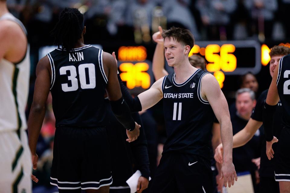 Utah State guard Max Shulga (11) reacts with forward Dan Akin (30) after a play against the Colorado State at Moby Arena. (Isaiah J. Downing, USA TODAY Sports)