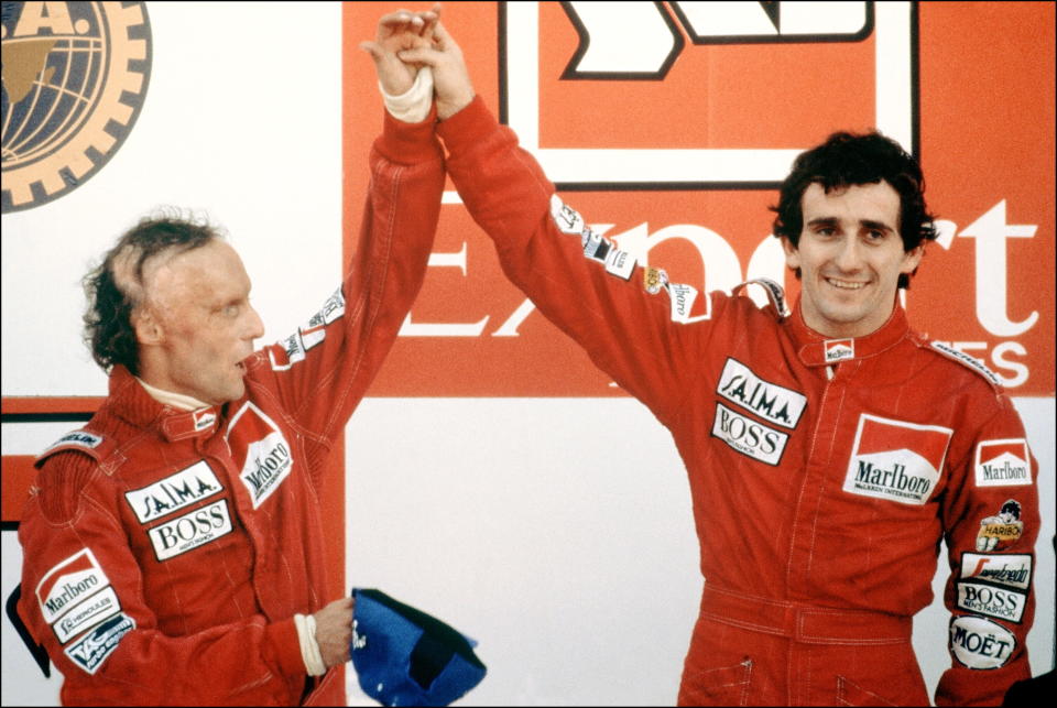 Lauda and his teammate Prost wave to the crowd at the end of the Portuguese Grand Prix in Estoril on October 21st 1984. (Photo by GABRIEL DUVAL/AFP/Getty Images)