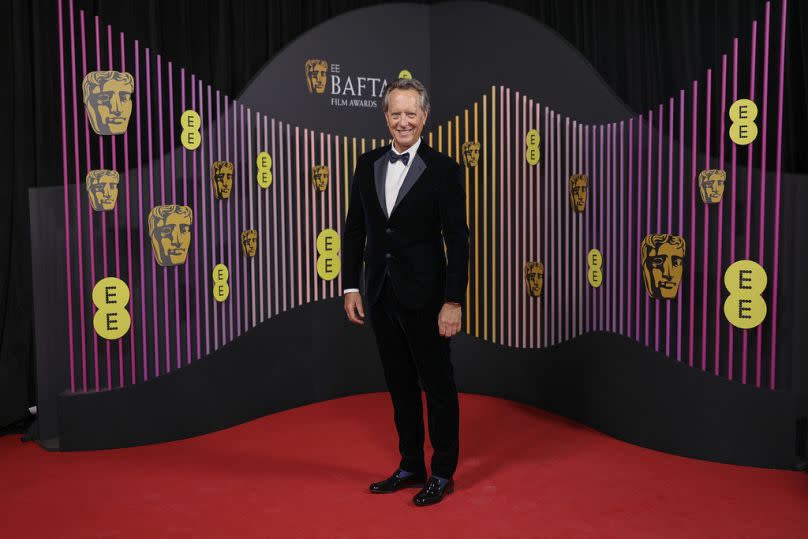 Richard E Grant pose for photographers upon arrival at the 77th British Academy Film Awards, BAFTA's 2024