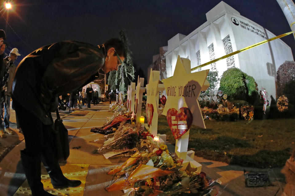 A woman pauses at a memorial outside of the Tree of Life Synagogue in Pittsburgh, where a gunman killed 11 congregants there in 2018