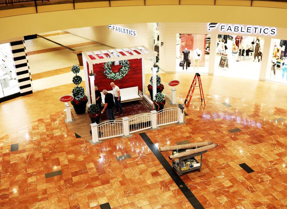 Workers set the stage for Santa's arrival at Jordan Creek Town Center, 101 Jordan Creek Parkway, in West Des Moines.