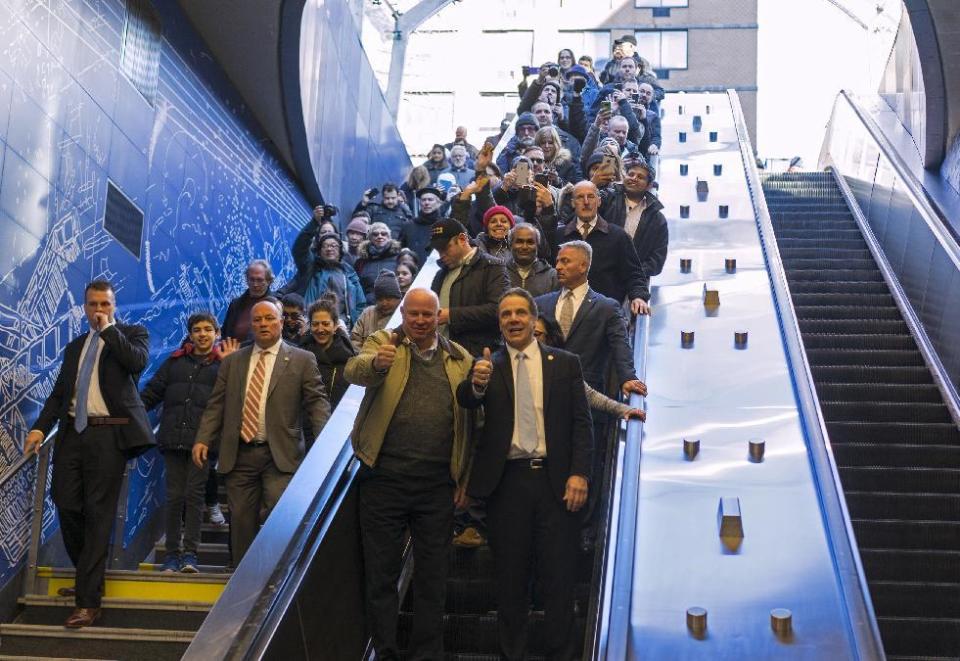 MTA Chairman and CEO Thomas Prendergast , center left, and New York Gov. Andrew Cuomo, center right, enter the newly opened 96th Street station of the Second Ave. Subway along with riders in New York Sunday, Jan. 1, 2017. The opening of three new stations on the newly opened Second Ave. subway marks a decades long plan to bring rail transportation to Manhattan's Upper East Side. (AP Photo/Craig Ruttle)