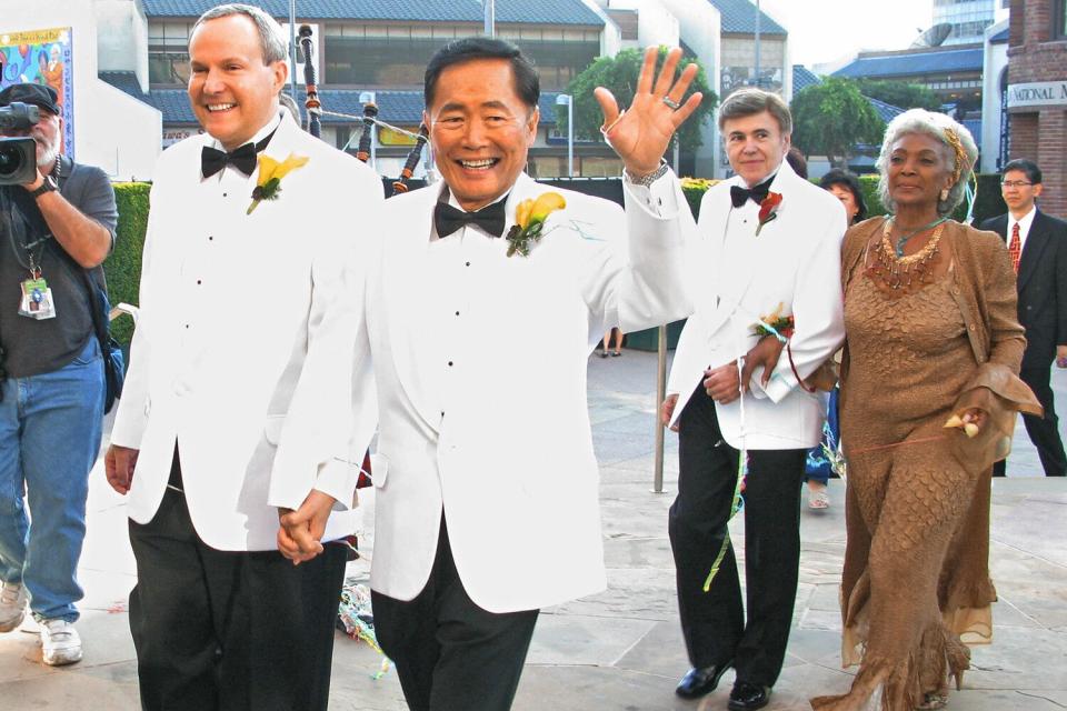 Actor George Takei (2nd L) (the "Sulu" charactor on "Star Trek") and partner Brad Altman (L) after they were married at the Japanese American National Museum on September 14, 2008 in Los Angeles. Fellow "Star Trek" actors Walter Koenig (2nd R) and Nichelle Nichols (R) who participated in the ceremony follow. AFP PHOTO/Stan HONDA (Photo credit should read STAN HONDA/AFP via Getty Images)