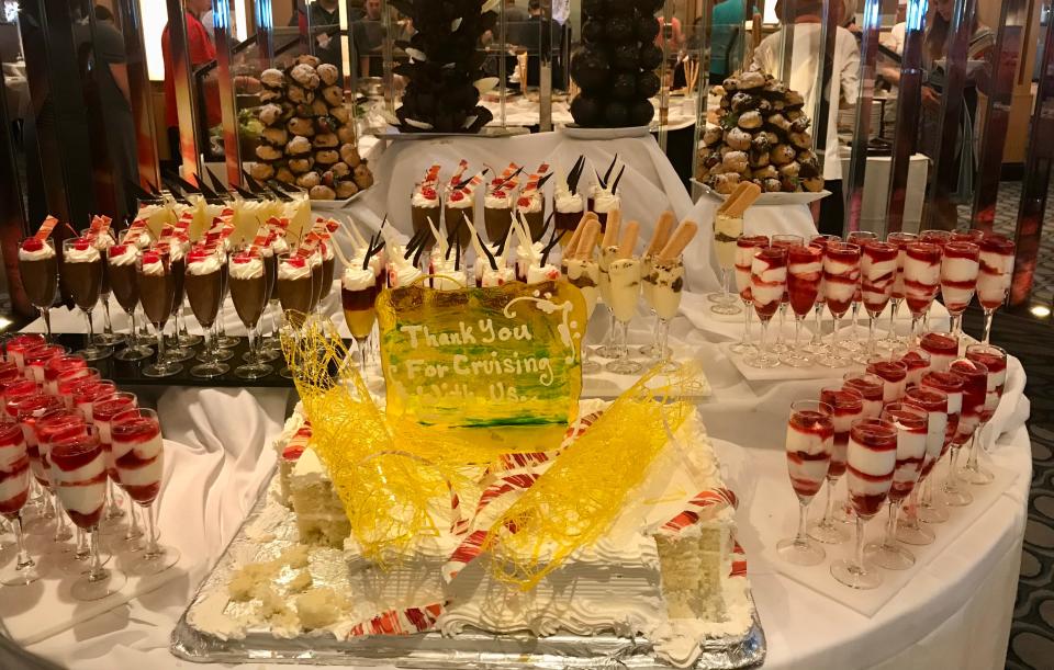 table full of fancy thank you desserts at the end of a cruise