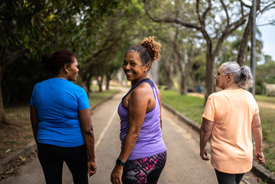 Portrait of a senior woman walking in the park with friends