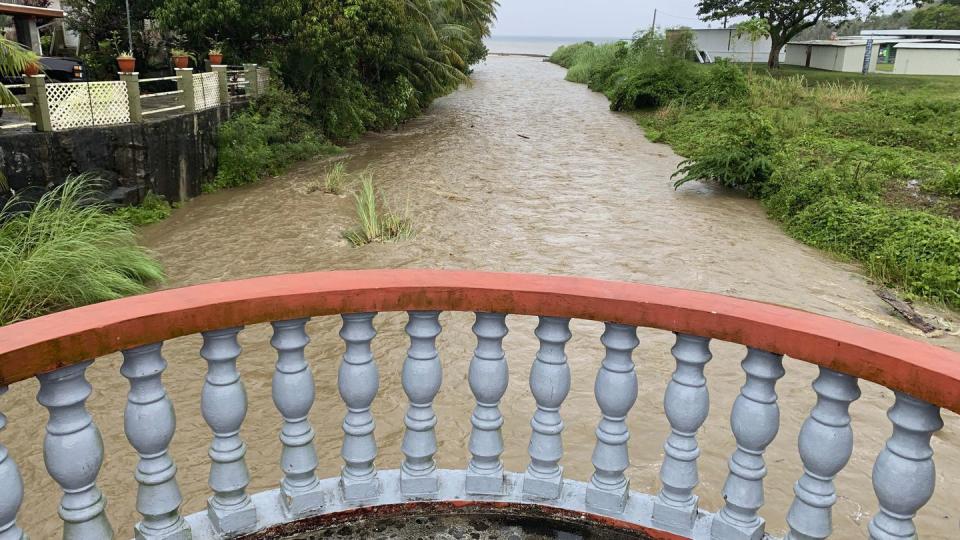 The Laelae River in Umatac, Guam, becomes swollen with the addition of rain runoff resulting from increased shower activity as Typhoon Mawar approaches the region on May 23, 2023. (Rick Cruz/The Pacific Daily via AP)