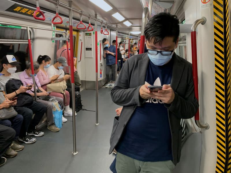 Passengers wear surgical masks in an MTR train in Hong Kong