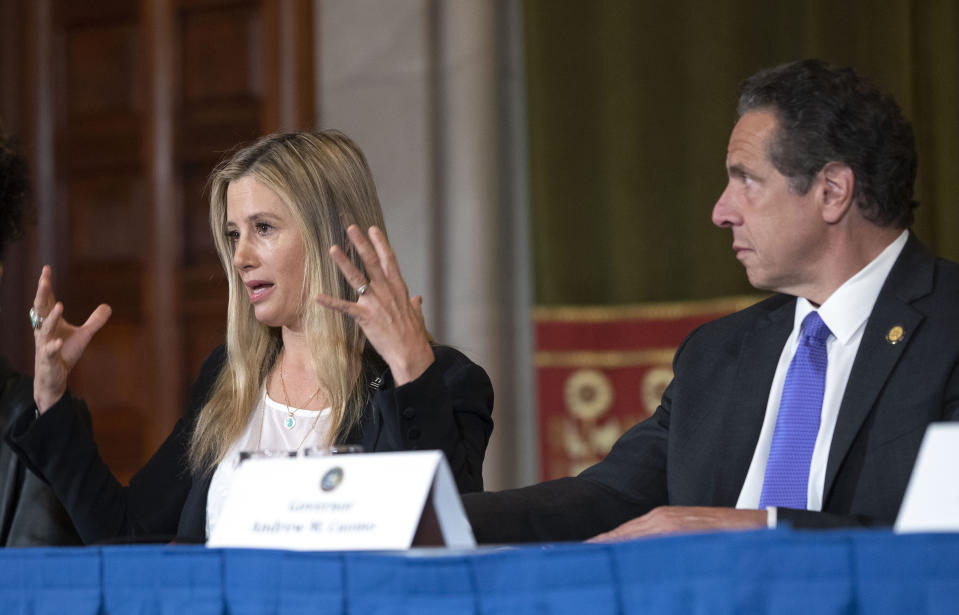 New York Gov. Andrew Cuomo, right, listens to Oscar-winning actress Mira Sorvino as she joined Times's Up advocates speaking out about sexual assault at the State Capitol in Albany, N.Y., Tuesday, June 12, 2019. Sorvino has revealed that she's a survivor of date rape in an attempt to lend her voice to a push for stronger sexual assault laws in New York. (Mike Groll/Office of Governor Andrew M. Cuomo via AP)