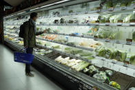 A resident looks at fresh produces at a supermarket in Beijing, Friday, Nov. 25, 2022. Residents of China's capital were emptying supermarket shelves and overwhelming delivery apps Friday as the city government ordered accelerated construction of COVID-19 quarantine centers and field hospitals. (AP Photo/Ng Han Guan)