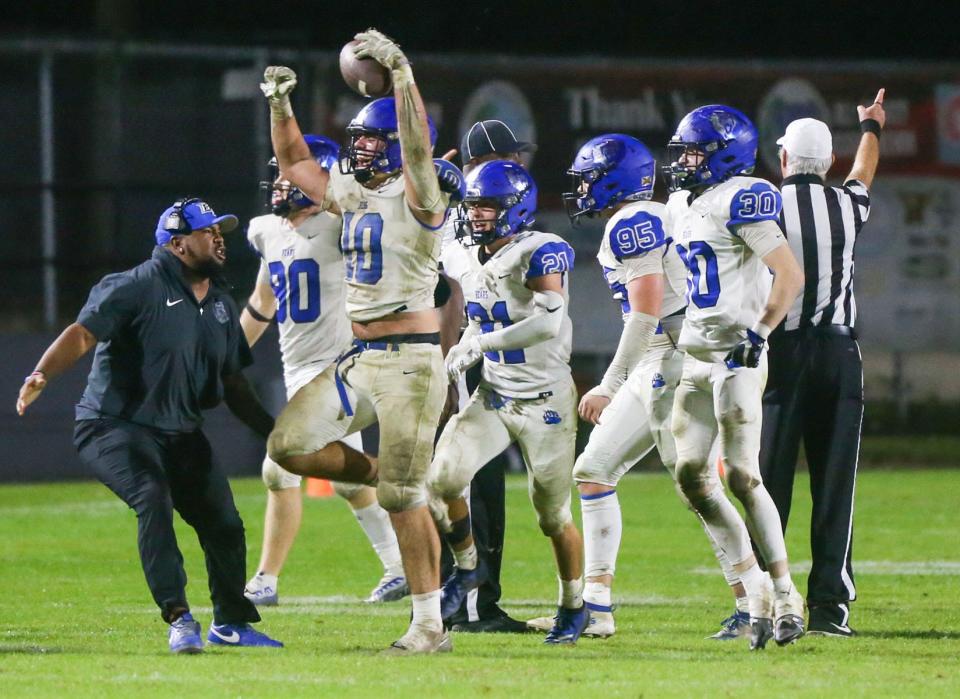 Bartram Trail linebacker Caden Baldwin (10) holds the ball aloft after recovering a clinching fumble against Niceville.