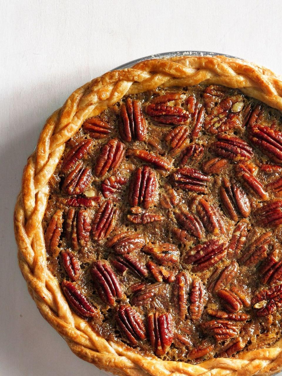 old fashioned pecan pie with a braided pie crust around the edges