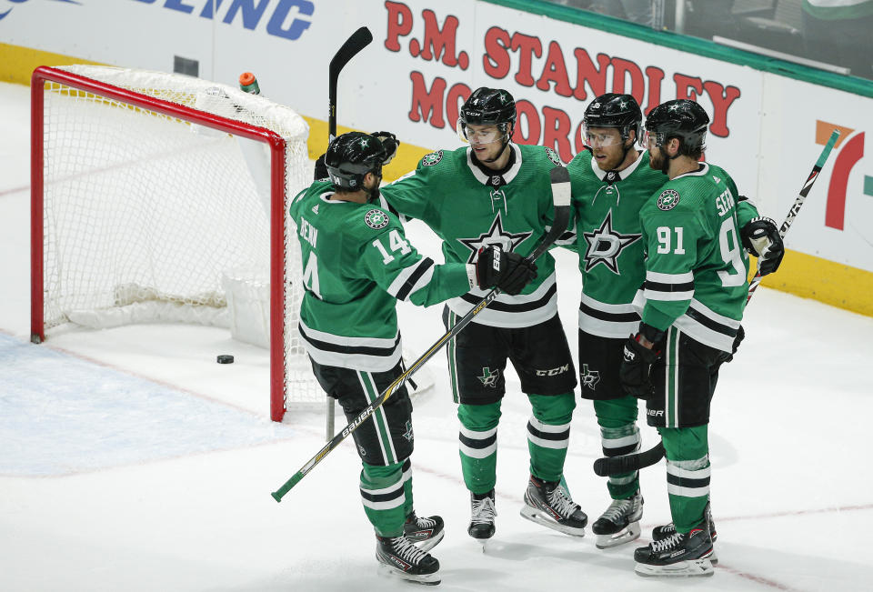 Dallas Stars forward Joe Pavelski, second from right, is congratulated by teammates after scoring in overtime of the team's NHL hockey game against the Winnipeg Jets on Thursday, Dec. 5, 2019, in Dallas. Dallas won 3-2. (AP Photo/Brandon Wade)