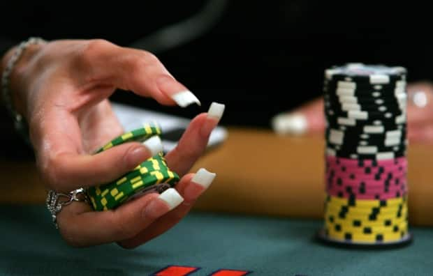 A poker player plays with her chips at the Rio Hotel & Casino in Las Vegas. (Ethan Miller/Getty Images - image credit)