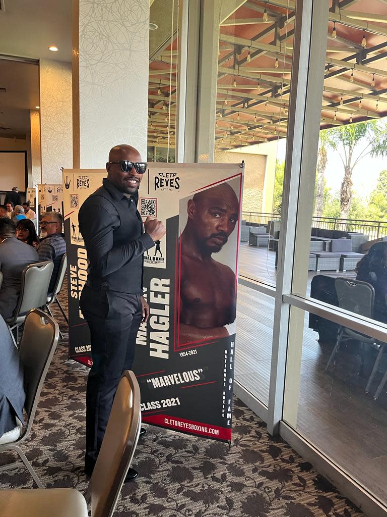 James Hagler Jr. poses in front of a picture of his grandfather, legendary boxer Marvelous Marvin Hagler of Brockton, at the International Boxing Hall of Fame in Canastota, New York. Hagler Jr. will make his Massachusetts ring debut on May 14 in Dedham.