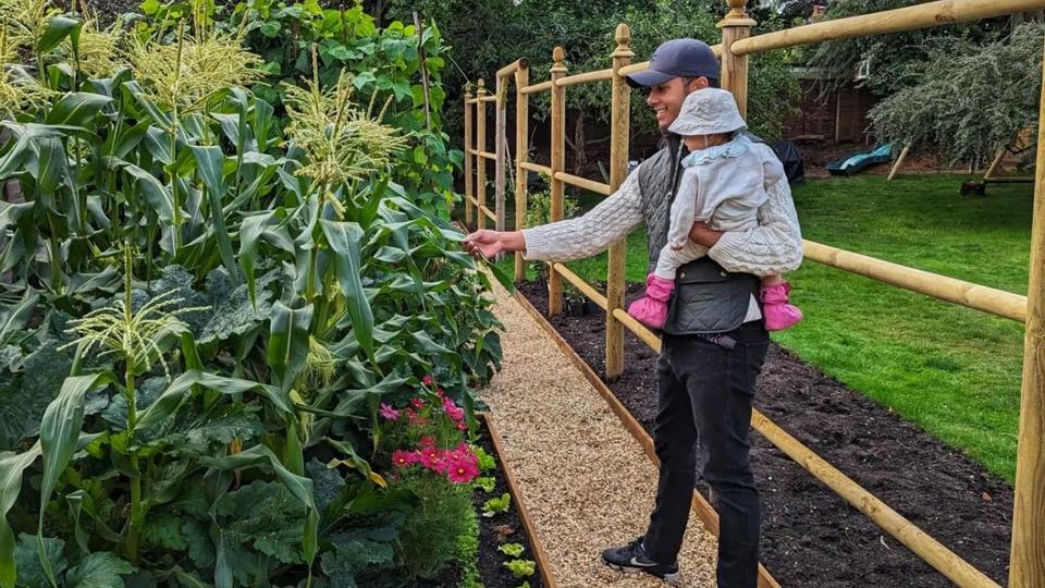 Will Kirk vegetable picking with his daughter