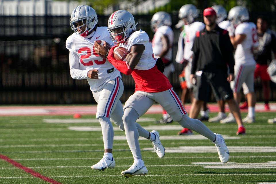 Aug 11, 2022; Columbus, OH, USA;  Ohio State Buckeyes safeties Kye Stokes (37) and Jaylen Johnson (25) catch passes during football camp at the Woody Hayes Athletic Center. Mandatory Credit: Adam Cairns-The Columbus Dispatch