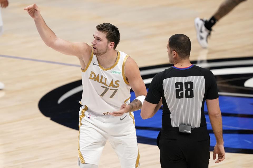 Dallas Mavericks' Luka Doncic (77) talks to referee Mousa Dagher (28) about a call on his attempted shot that was blocked in the first half of an NBA basketball game against the Toronto Raptors in Dallas, Friday, May 14, 2021. (AP Photo/Tony Gutierrez)