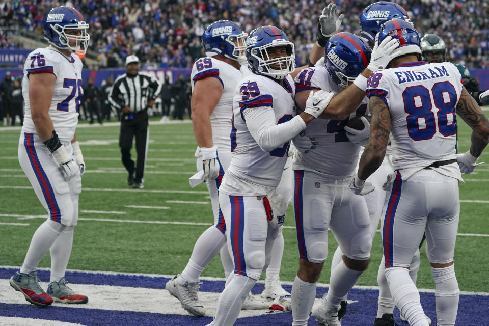 New York Giants' Chris Myarick (41), second from right, celebrates his touchdown during the second half of an NFL football game against the Philadelphia Eagles, Sunday, Nov. 28, 2021, in East Rutherford, N.J. (AP Photo/Corey Sipkin)