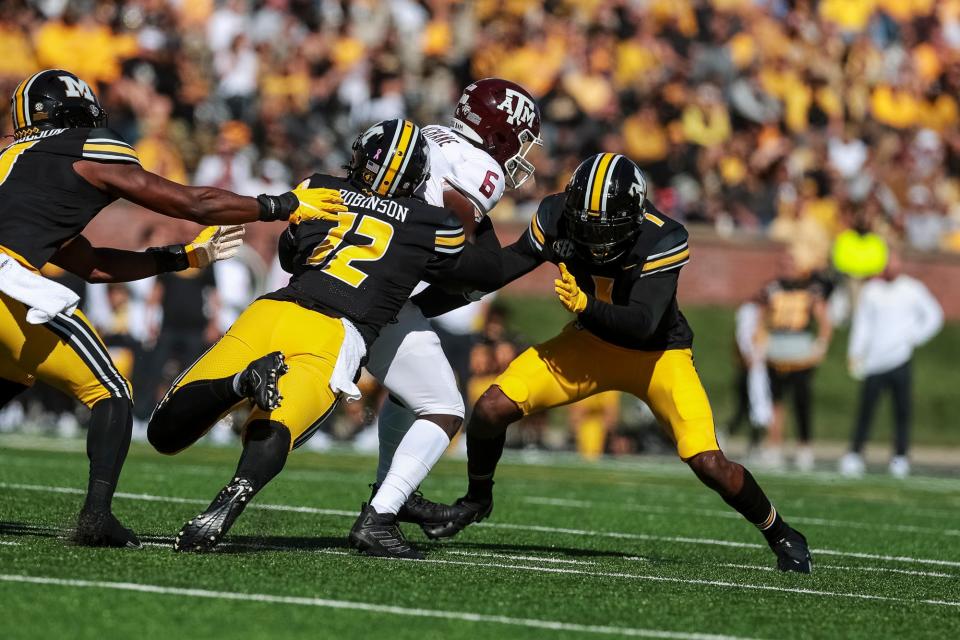 Missouri Tigers defensive back Shawn Robinson (12) tackles Texas A&M Aggies running back Devon Achane (6) during a game Oct. 16 at Faurot Field.