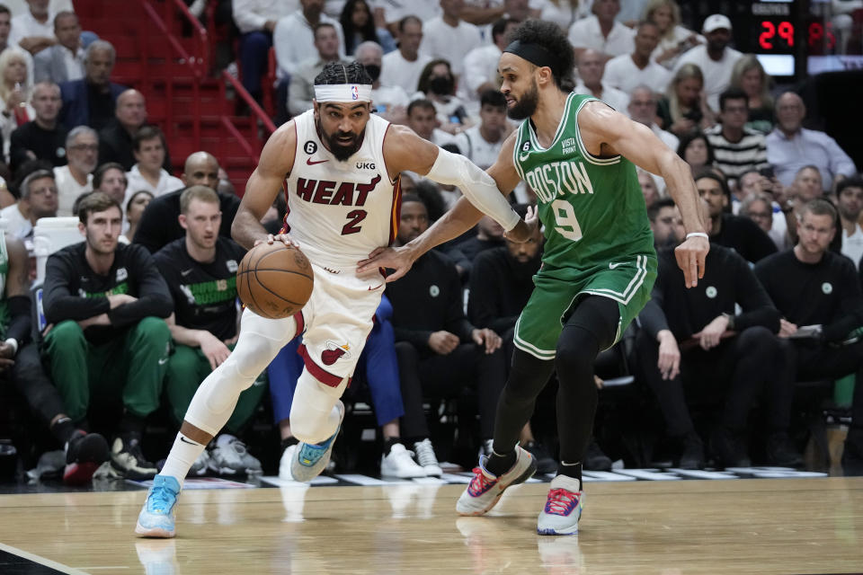 Boston Celtics guard Derrick White (9) defends Miami Heat guard Gabe Vincent (2) during the first half of Game 4 during the NBA basketball playoffs Eastern Conference finals, Tuesday, May 23, 2023, in Miami. (AP Photo/Wilfredo Lee)