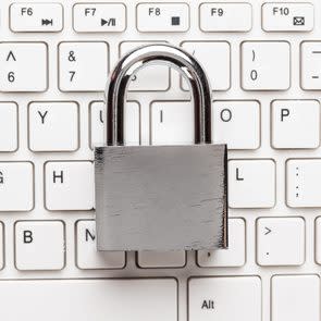 padlock and white computer keyboard on the wooden office table. privacy protection, encrypted connection concept