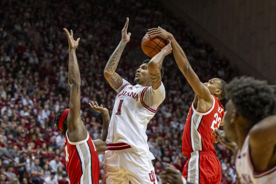 Ohio State forward Zed Key, second from right, strips the ball from Indiana center Kel'el Ware (1) on a shot attempt during the second half of an NCAA college basketball game Saturday, Jan. 6, 2024, in Bloomington, Ind. (AP Photo/Doug McSchooler)