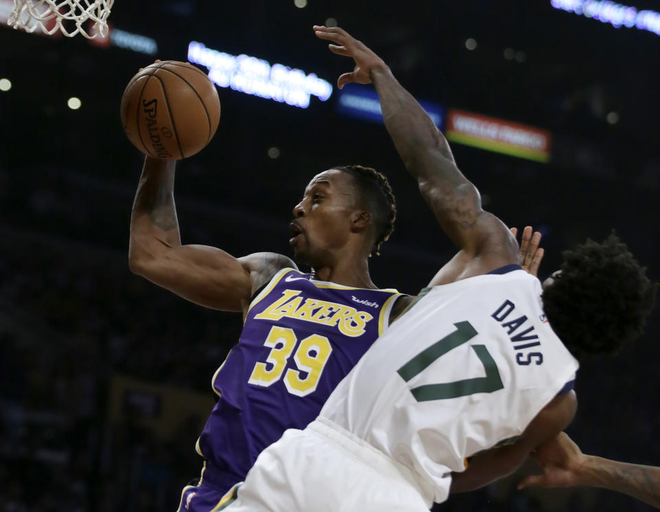 Los Angeles Lakers center Dwight Howard, left, rebounds the ball next to Utah Jazz center Ed Davis during the first half of an NBA basketball game in Los Angeles, Friday, Oct. 25, 2019. (AP Photo/Alex Gallardo)