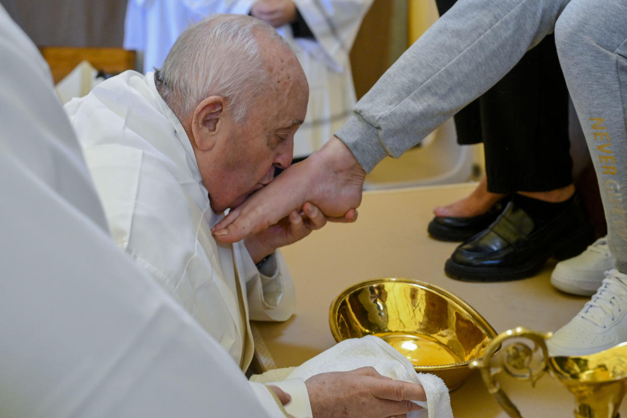 Pope Francis kisses the foot of a woman inmate. The Holy Thursday foot-washing ceremony is a hallmark of every Holy Week and recalls the foot-washing Jesus performed on his 12 apostles at their last supper together before he was crucified.  / Credit: Vatican Media / AP