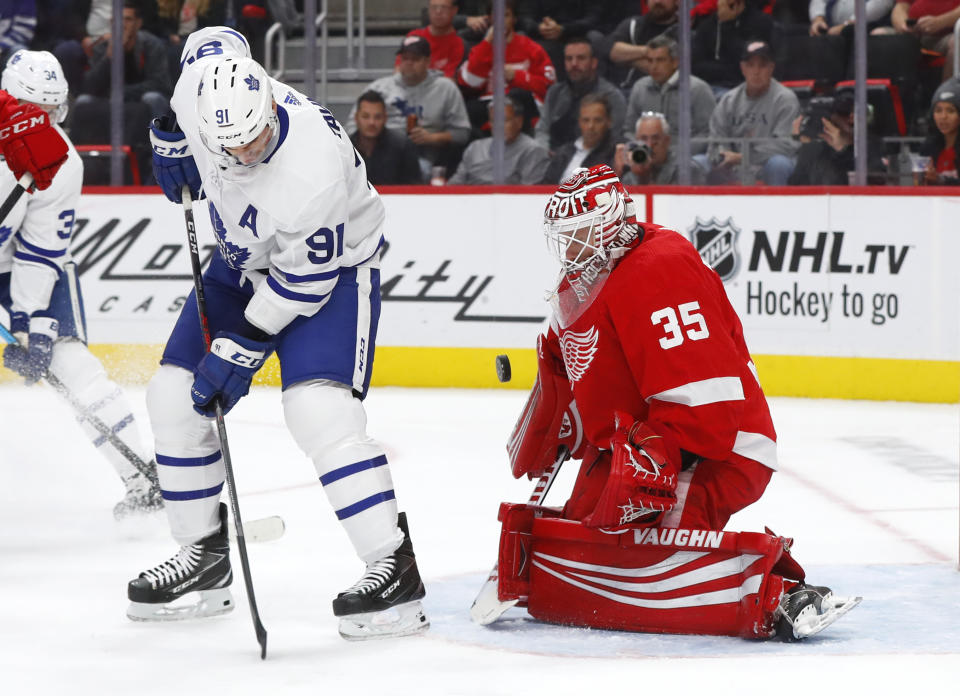 Detroit Red Wings goaltender Jimmy Howard (35) stops a deflection by Toronto Maple Leafs center John Tavares (91) during the first period of an NHL hockey game Thursday, Oct. 11, 2018, in Detroit. (AP Photo/Paul Sancya)